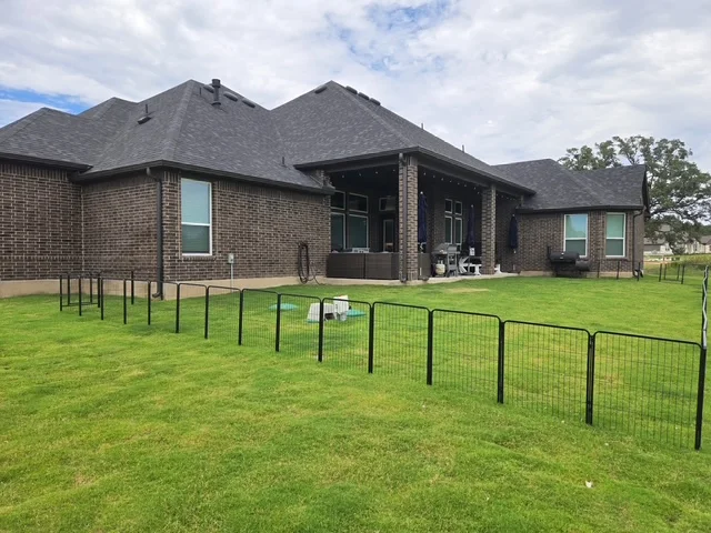 Dark seamless gutters installed by S&H across a large residential roofline