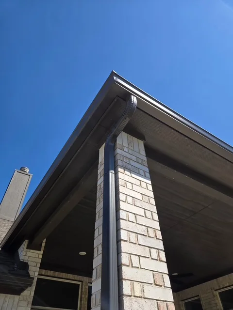 Close view of a finished S&H gutter corner and downspout connection
